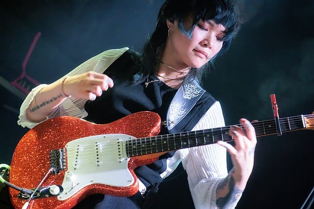 a woman playing a guitar