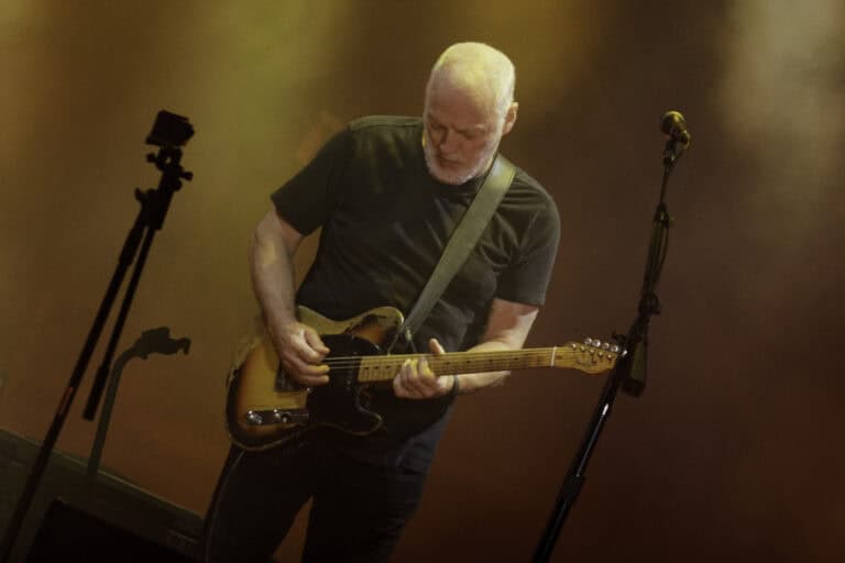 a man playing a guitar on a stage