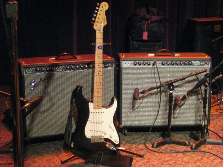a guitar and amps on a stage