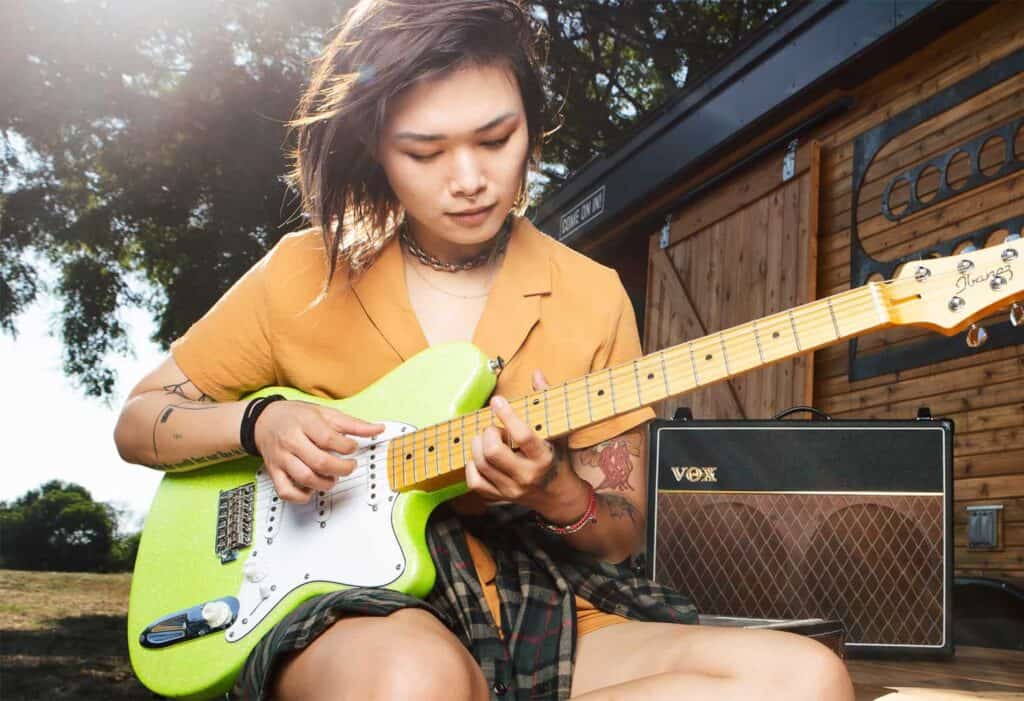 a woman playing a guitar
