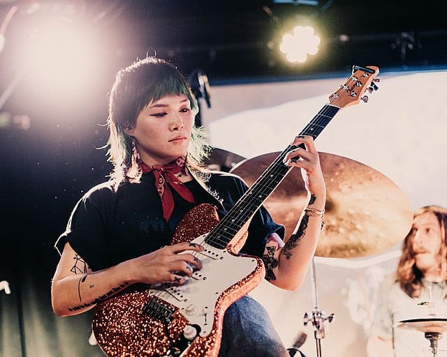 a woman playing a guitar