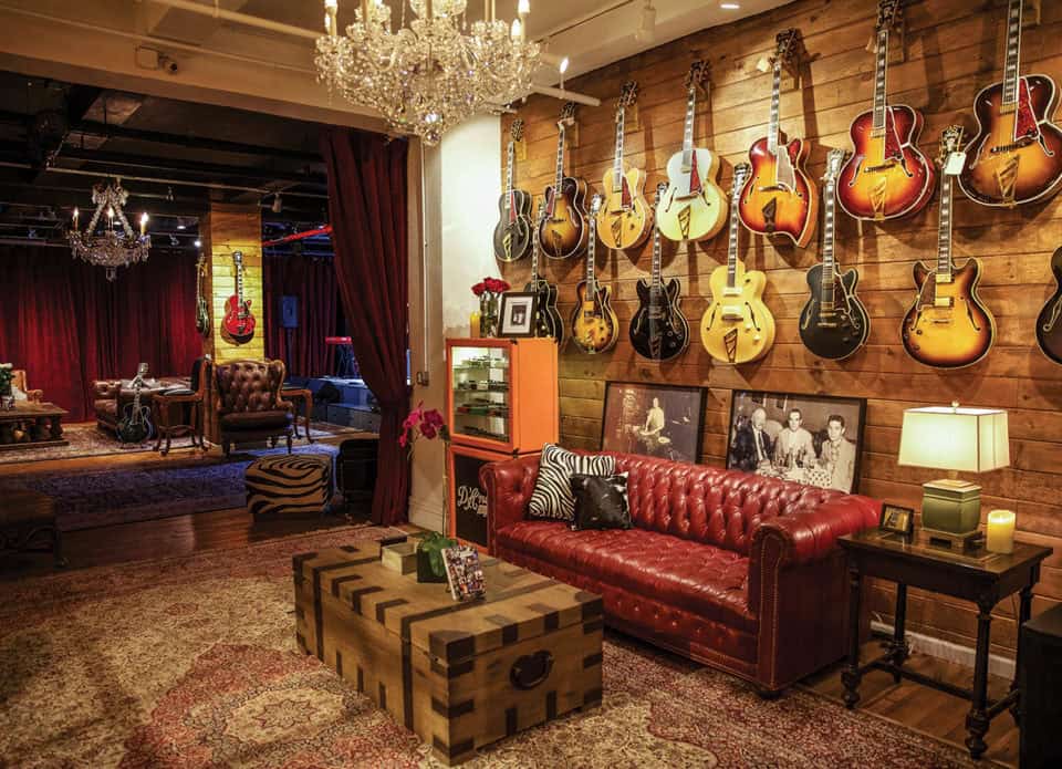 a room with d'angelico guitars on the wall