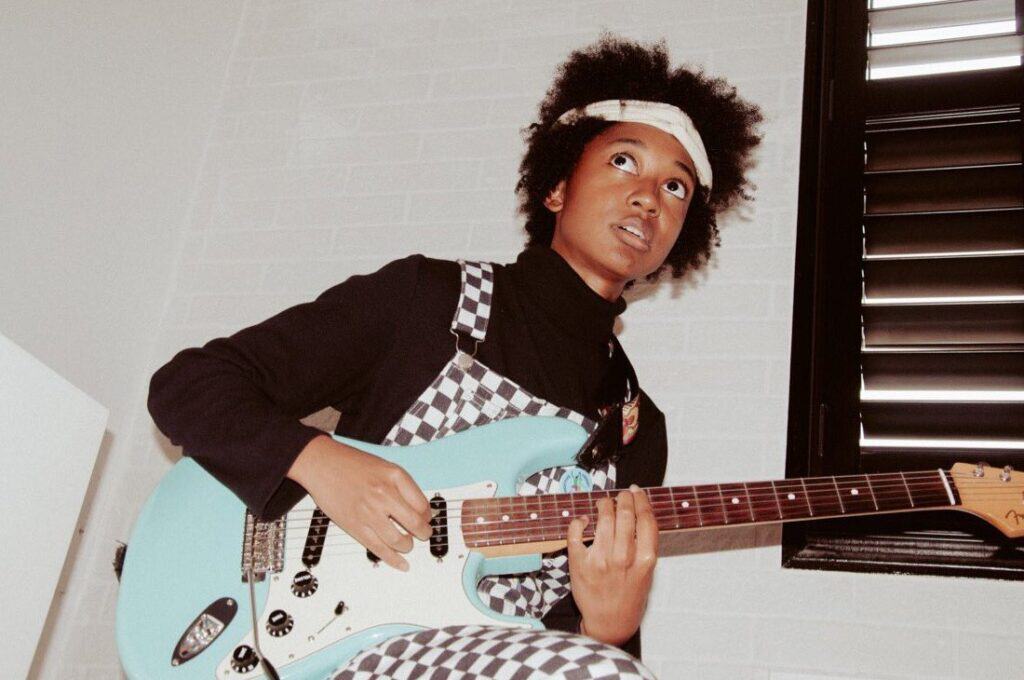 melanie faye playing a fender stratocaster guitar