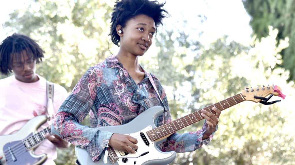 melanie faye playing a fender stratocaster guitar