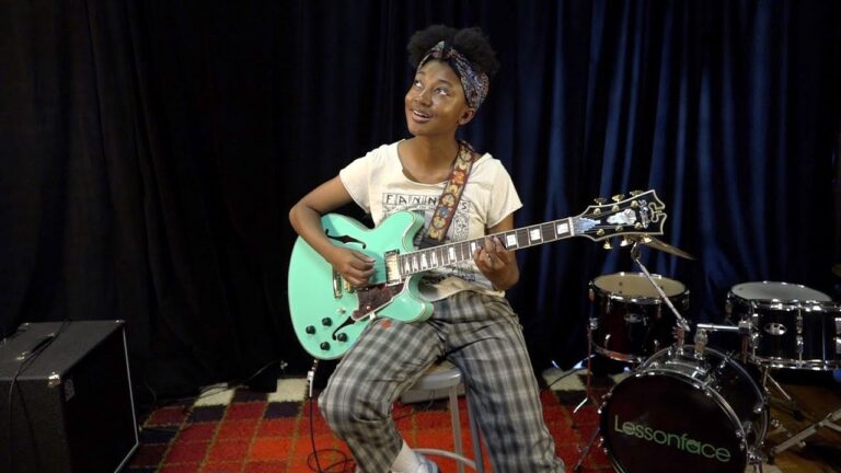 melanie faye playing her signature D'Angelico Deluxe DC LI guitar