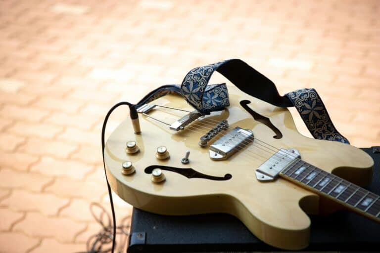 a guitar with a strap attached to it