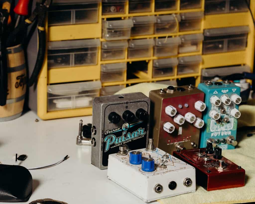 Close-up of various guitar effects pedals organized on a workbench. Ideal for music tech concepts.