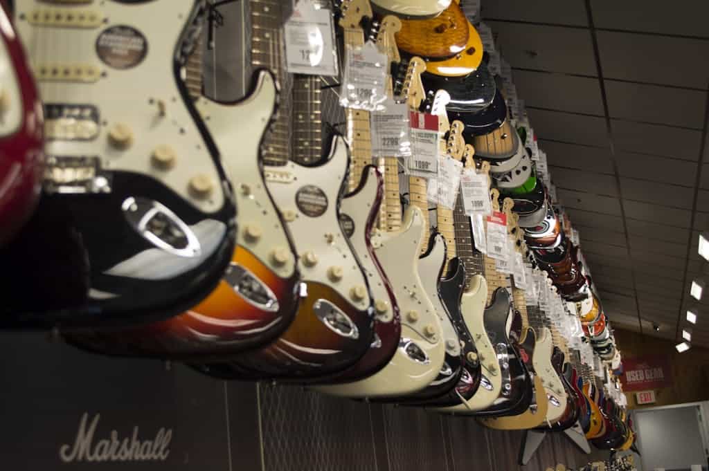 a row of guitars in a store